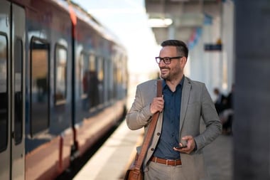 Young businessman using mobile phone at train_small